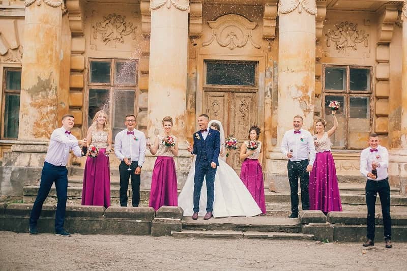 Wedding party by brick building