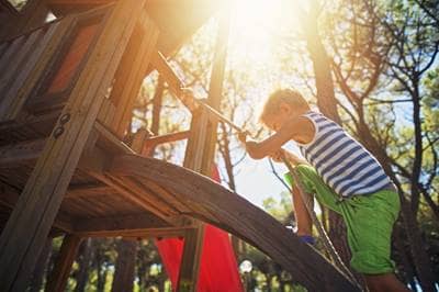 Boy climbing up rope