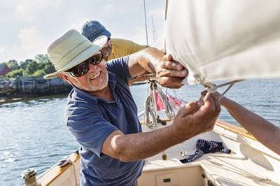 Older man rigging a sailboat
