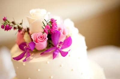 Wedding cake with pink and purple flowers